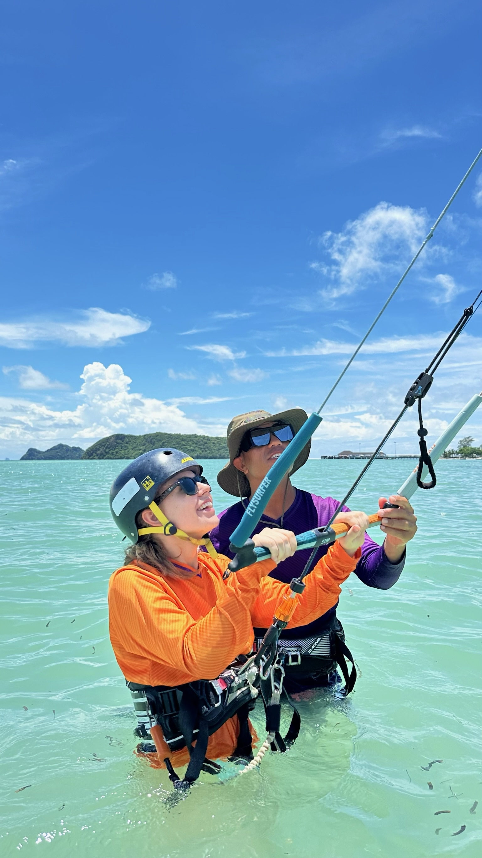 IKO kitesurfing lesson with radio helmet coaching at Koh Phangan — instructor and student on flat water lagoon