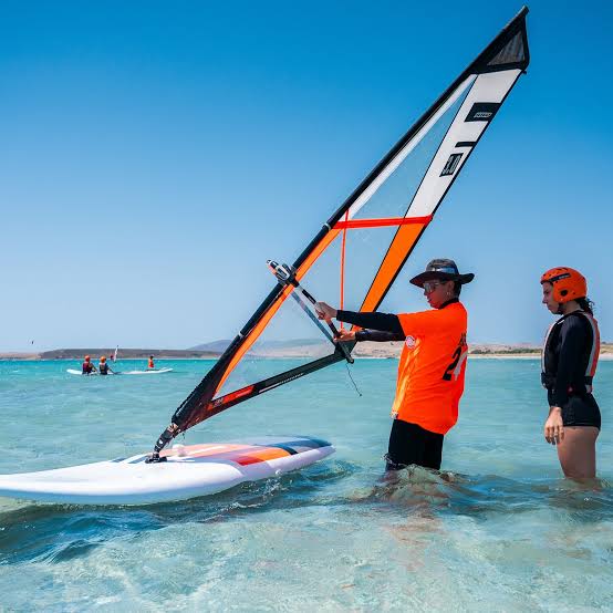 Learn to windsurf at Koh Phangan — windsurfing instructor coaching on flat water lagoon